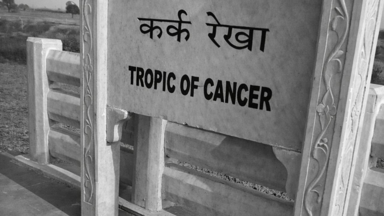 Side angle view of Tropic of Cancer line marker with stone structure and white alignment line in Gujarat (representative image).